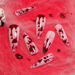 Long stiletto press-on nails with red blood drip designs for Halloween festival