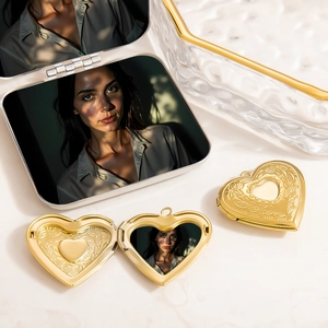 Macro detail of a golden heart locket pendant with photo compartment and gift box