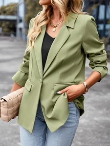 Detail of short sleeve green blazer lapel and button closure for casual business wear