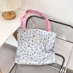 Close-up of quilted canvas tote with cute cat prints and blue pink color contrast