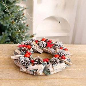 Rustic Christmas wreath with pine cones red stars and ornaments on a wooden table