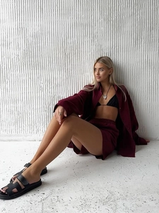 Detail of burgundy linen set with button-up long sleeve shirt and drawstring shorts