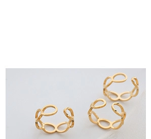 Close-up of three gold hollow chain-link adjustable open rings on a grey background