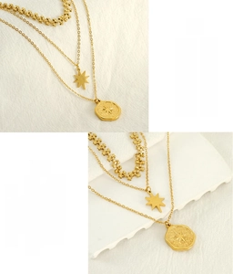 Close-up of gold layered necklace featuring star pendant and engraved coin in stainless steel