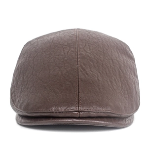 Detailed view of dark brown textured leather flat cap with decorative stitching