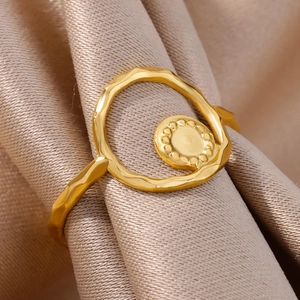 Macro shot of 18k gold plated stainless steel ring with wave shape and beaded circle detail