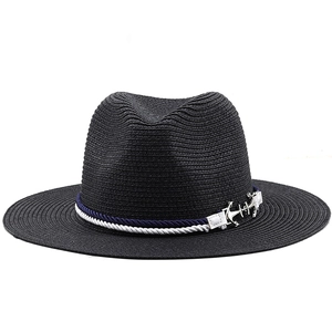 Detail of nautical blue and white rope with a metallic silver anchor on a black Panama hat