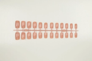 Detail view of 20 pieces solid nude matte square long press-on nails on plastic frame
