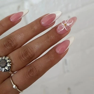 French tip almond press-on nails with 3D white flower design on a soft pink base