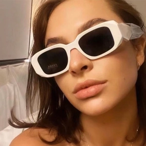 Close-up of model wearing white wrap sports sunglasses with dark UV lenses