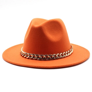 Detailed close-up of orange wool fedora hat featuring a chunky gold metal chain link trim