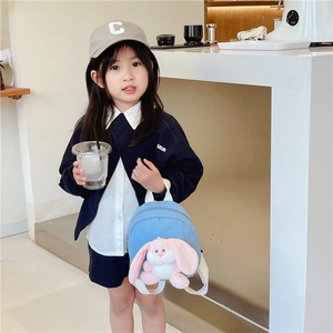 Blue kids canvas backpack featuring a pink plush long-eared bunny toy for toddlers