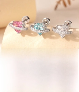 Macro detail of titanium steel heart star ear studs with pink blue and white zircon