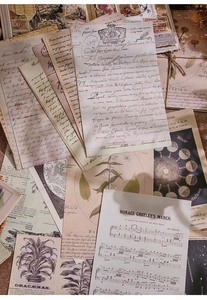 Macro detail of vintage scrapbooking paper with botanical, lunar, and musical score elements
