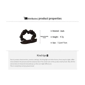 Close-up of dark brown scrunchie with bow detail showing 7.2cm dimensions and texture