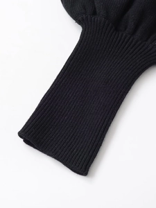 Detailed close-up of black ribbed knit cuffs showing fine texture and elastic fabric weave