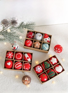 Three boxes of Christmas felt ornaments featuring gingerbread men and snowflakes on white rug