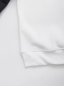 Close-up of premium white sweatshirt ribbed hem with high-quality double-needle stitching