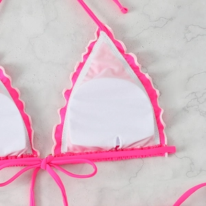 Detail of rose pink halter bikini top showing mesh lining and removable round breast pads
