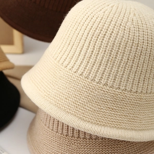 Gros plan de bobs en maille montrant la texture épaisse et le bord roulé en diverses couleurs