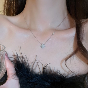 Close-up of sparkling silver star necklace with rhinestones on model neck