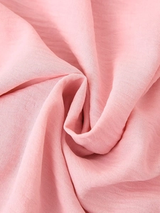 Macro shot showing pink chiffon fabric texture and soft drape of the two-piece set