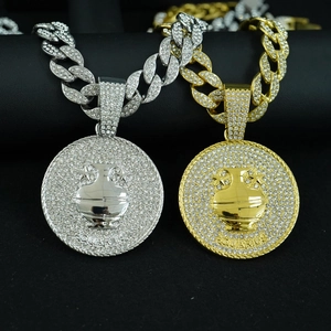 Macro shot of gold and silver Aquarius zodiac pendants with rhinestones on Cuban link chains
