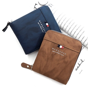 Detail of blue and brown trifold men's wallets with L-shaped zipper and leather texture