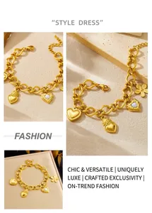 Close-up of gold-plated stainless steel chain bracelet with heart and flower pendants