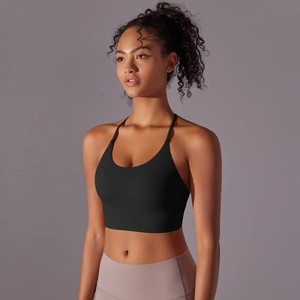 Detail of cross-back straps on black sports bra for yoga with breathable elastic fabric