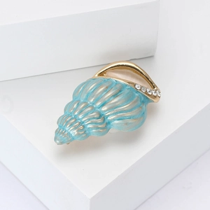 Elegant shell-shaped alloy brooch with blue enamel, gold plating and sparkling rhinestones