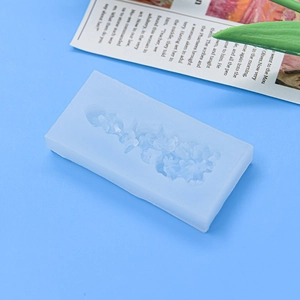 Light blue rectangular silicone mold with intricate rose flower patterns for cake baking