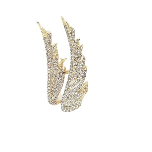 Golden feather wing open ring with sparkling white rhinestones on a white background