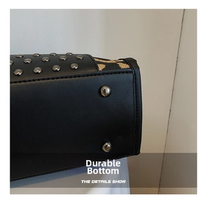 Detail of black leather handbag base with silver rivets and colorful woven stitching