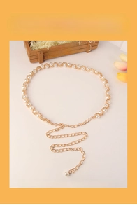 Detailed view of adjustable gold-tone pearl chain belt for elegant dresses