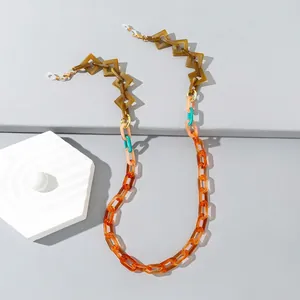 Detail view of colorful acrylic glasses chain with amber and orange geometric links