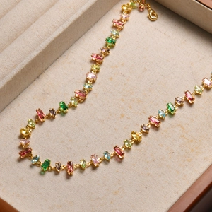 Detailed macro view of rainbow crystal necklace with colorful gems in gold setting