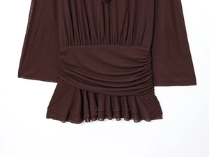 Detailed view of dark brown V-neck dress featuring ruched waist and layered ruffle hemline