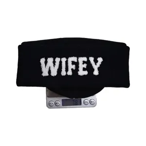 Black knit beanie with white Chenille WIFEY embroidery on cuff shown on weighing scale