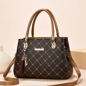 Deep brown quilted faux leather tote bag with gold handles and tassel for middle-aged women