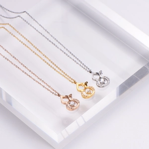 Titanium steel gourd pendants in gold, rose gold, and silver finishes with sparkling zircons