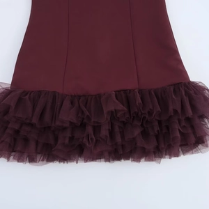 Detailed macro view of the burgundy dress hem with layered tulle and ruffle mesh stitching