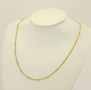Detail of 18K gold plated stainless steel satellite chain necklace on a white model bust