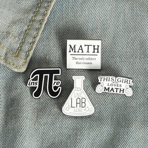 Set of 4 black and white science enamel pins featuring pi symbol and math quotes on denim