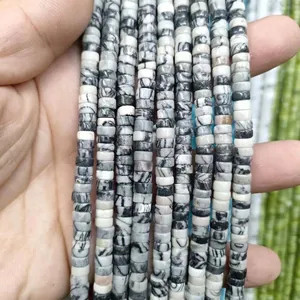 Macro detail of natural black and white marble heishi spacer beads for DIY jewelry making