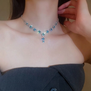 Elegant silver Y-shaped tassel necklace with sparkling sky blue crystals on model