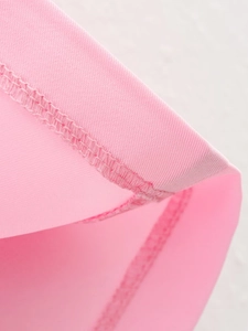 Detailed close-up of pink fabric showing fine knitted texture and durable double-stitched hem