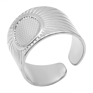 Macro detail of silver adjustable ring featuring a textured disc and radial patterns