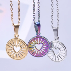 Detailed close-up of three heart-shaped necklaces in gold, silver and rainbow finish