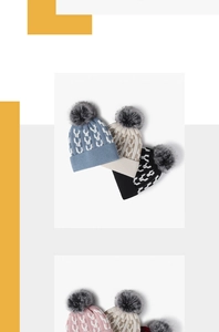 Detail of chunky knit winter hats with faux fur pompom and stylish geometric patterns